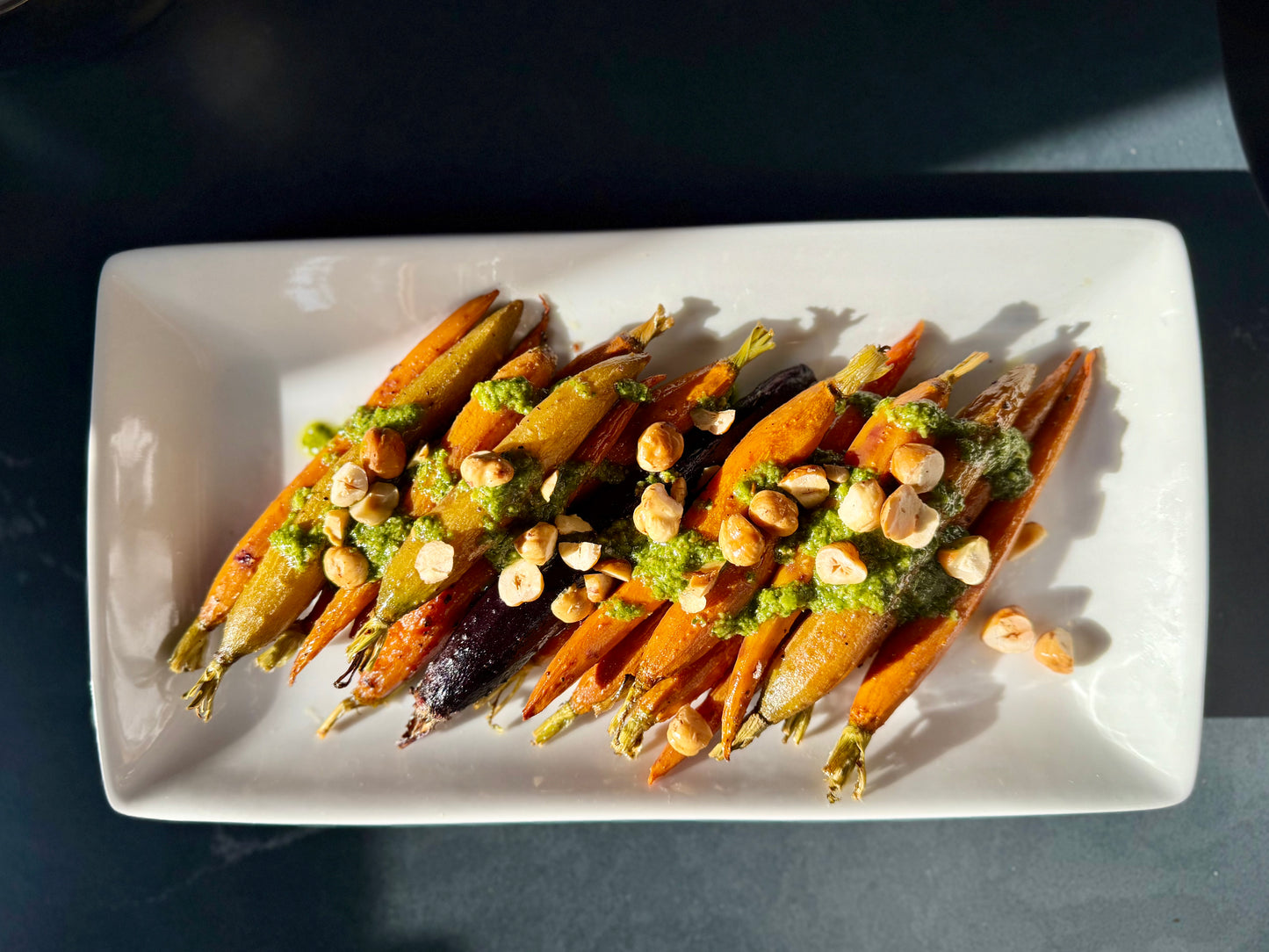Roasted Rainbow Carrots with Toasted Hazelnuts and Spicy Zhoug sauce.