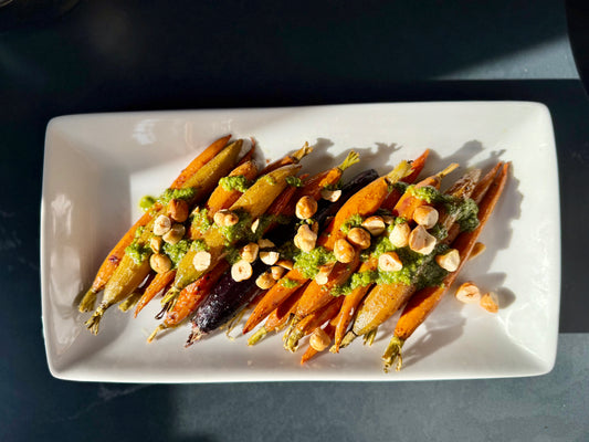 Roasted Rainbow Carrots with Toasted Hazelnuts and Spicy Zhoug sauce.